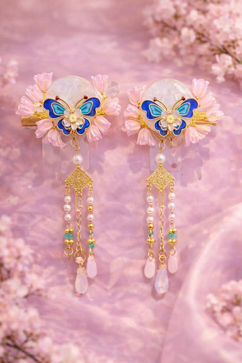 Blue butterfly hairclips with floral accents pearl bead details laying on a pink flowery fabric