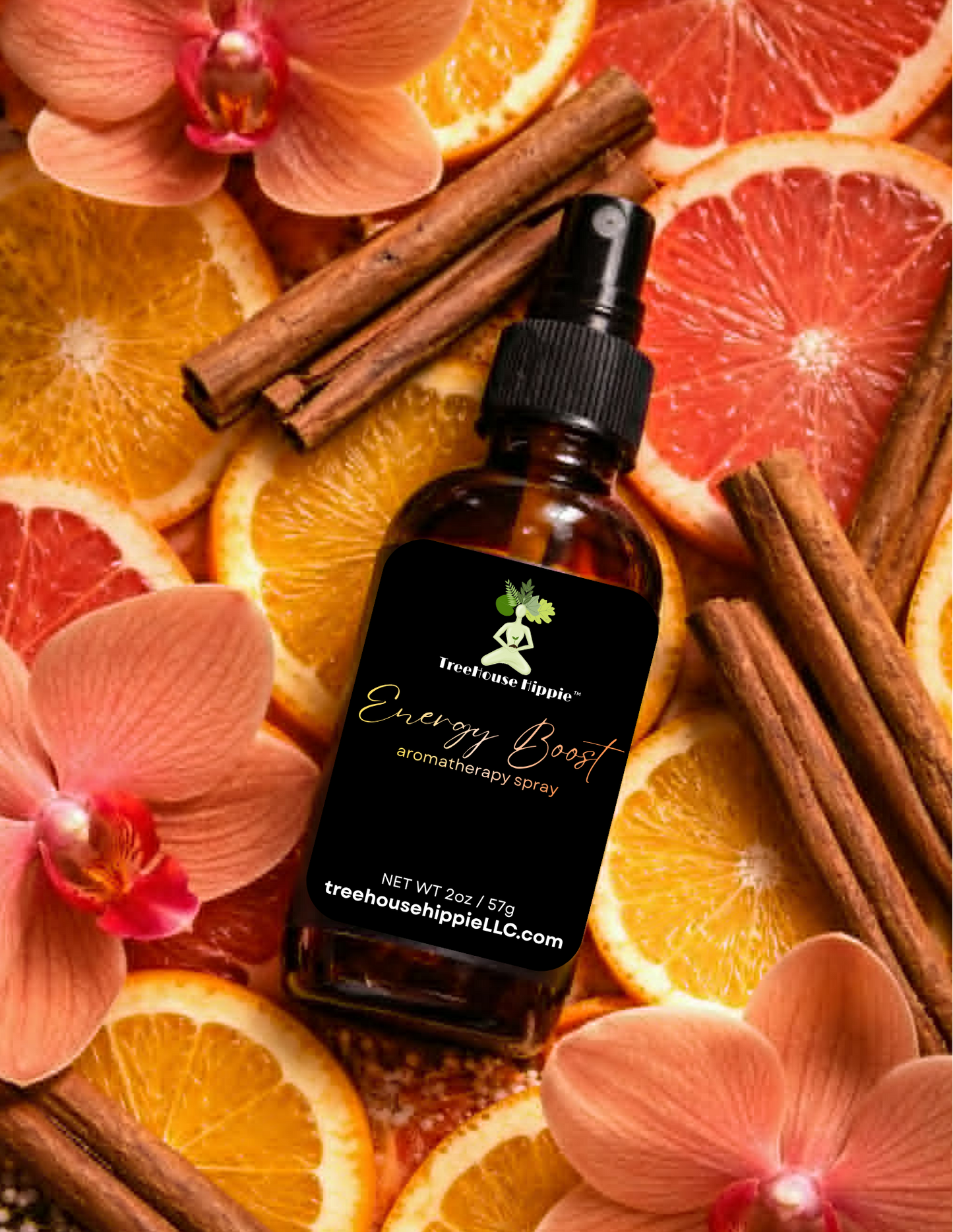 A bottle of TreeHouse Hippie's 'Energy Boost' Aromatherapy Room & Body Spray lying in a bed of orange slices, flowers, grapefruit slices, and cinnamon sticks.