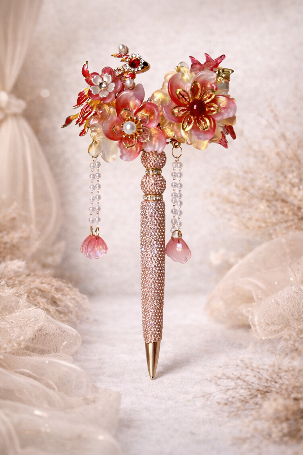 Extravagant double-sided ruby red bling pen with large flowers, smaller flower accents, shiny embellishments on a lace and linen background. 