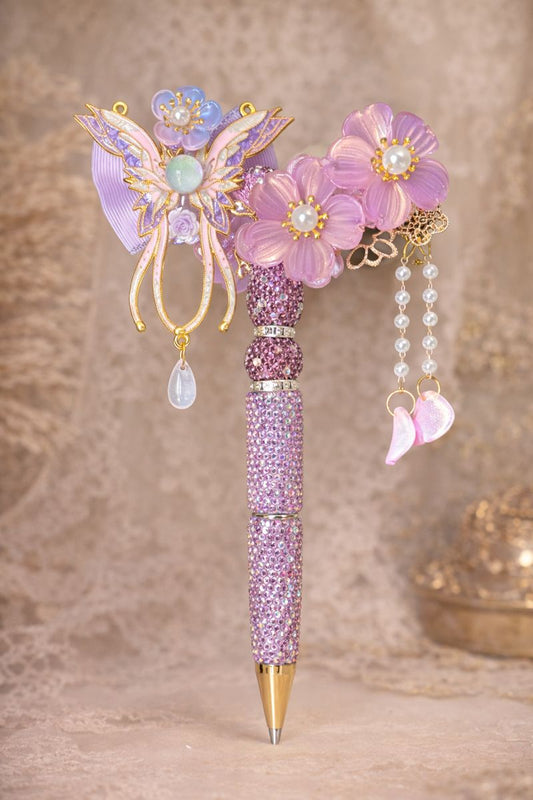 Extravagant decorative double-sided lavender bling pen with large flowers and a purple and cream colored butterfly on a lace-textured background
