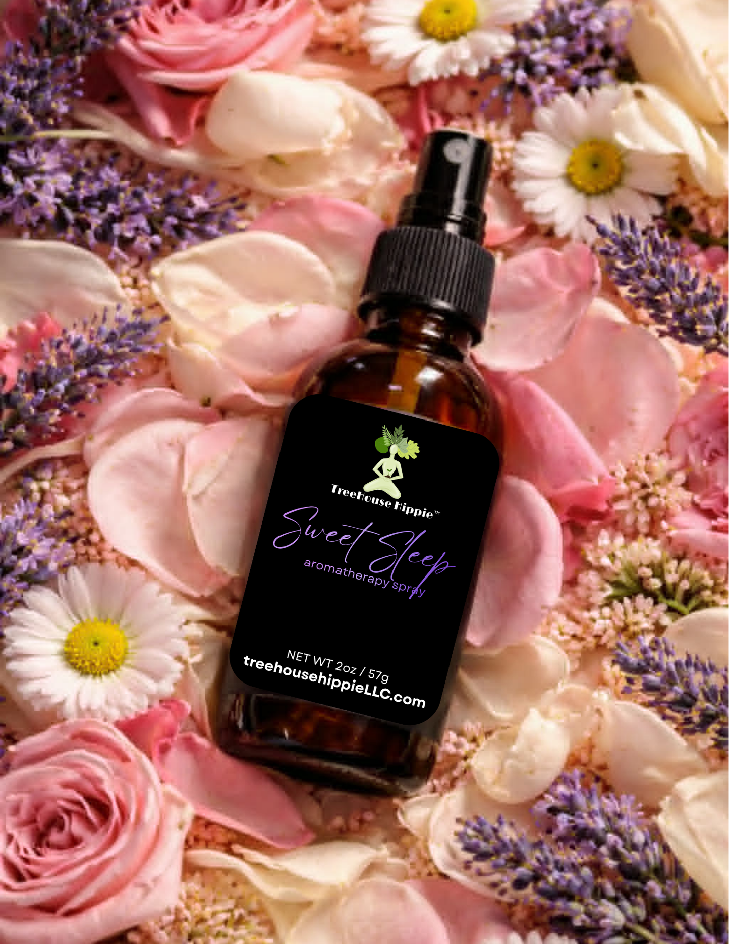 A bottle of TreeHouse Hippie's 'Sweet Sleep' Aromatherapy Room & Body Spray lying in a full bed of flowers and flower petals. 